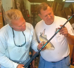 Legendary angler Roland Martin, left, examines a swordfish rod that Berry fabricated.