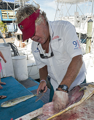 Bradeen filets a dolphin (mahii mahi) for his clients.
