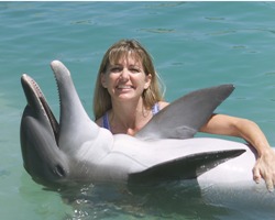Cheryl Messenger cradles a most cooperative dolphin for a photo opportunity. (Photos courtesy of Dolphin Connection)