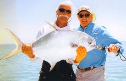 Fishing guide Chris Robinson (left) and his angler display a permit caught in Keys waters.