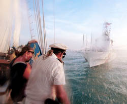 Captain Finbar Gittelman and his first mate, Julie McEnroe, of the Schooner Wolf, take a direct hit from a U.S. Coast Guard cutter's water cannon during the Conch Republic Days Naval Battle in the Key West harbor. Photos by Mike Hollar/Florida Keys News Bureau