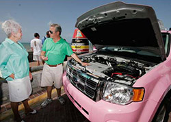 Glenn Stevenson of Five Sixes Taxi (right) shows Florida Keys commissioner Dixie Spehar the inner workings of the hybrid cab.