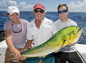 Bradeen, center, holds a nice dolphin with Veronica Pereira and Barron Pritt.