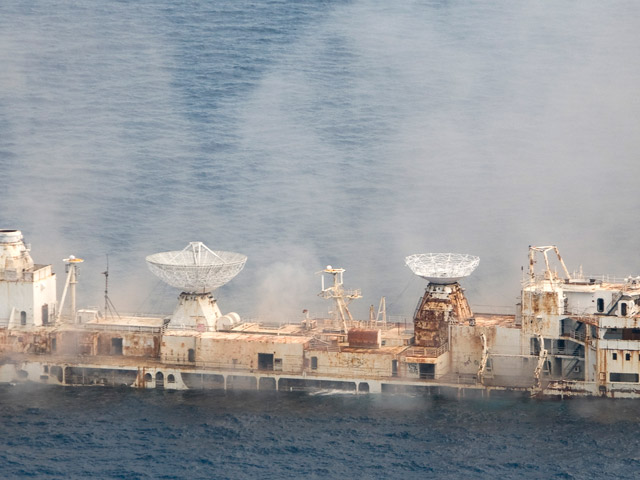 In this photo released by the Florida Keys News Bureau, the former U.S. Air Force missile-tracking ship Gen. Hoyt S. Vandenberg begins to sink after cutting charges were detonated Wednesday. May 27, 2009, seven miles off Key West, Fla. The 523-foot-long Vandenberg, that played a key role in the Cold War and tracked NASA spacecraft launches in the 1960s, 70s and early 80s, was scuttled to create an artificial reef to attract recreational divers and anglers. It sank in less then two minutes. (Andy Newman/Florida Keys News Bureau/HO)