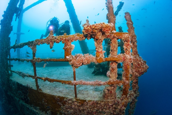 Two scuba divers exploring the Vandenberg shipwreck